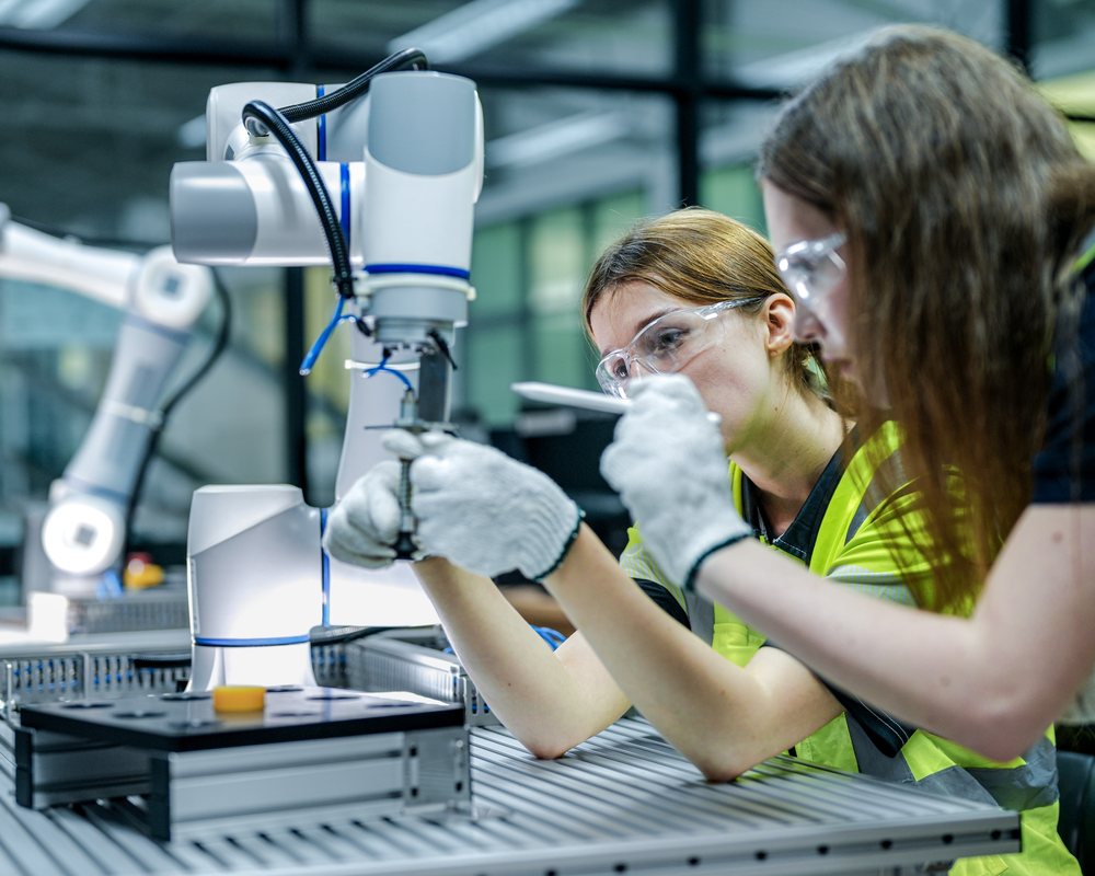Quality engineer with measurement tools reviewing Six Sigma process improvement data